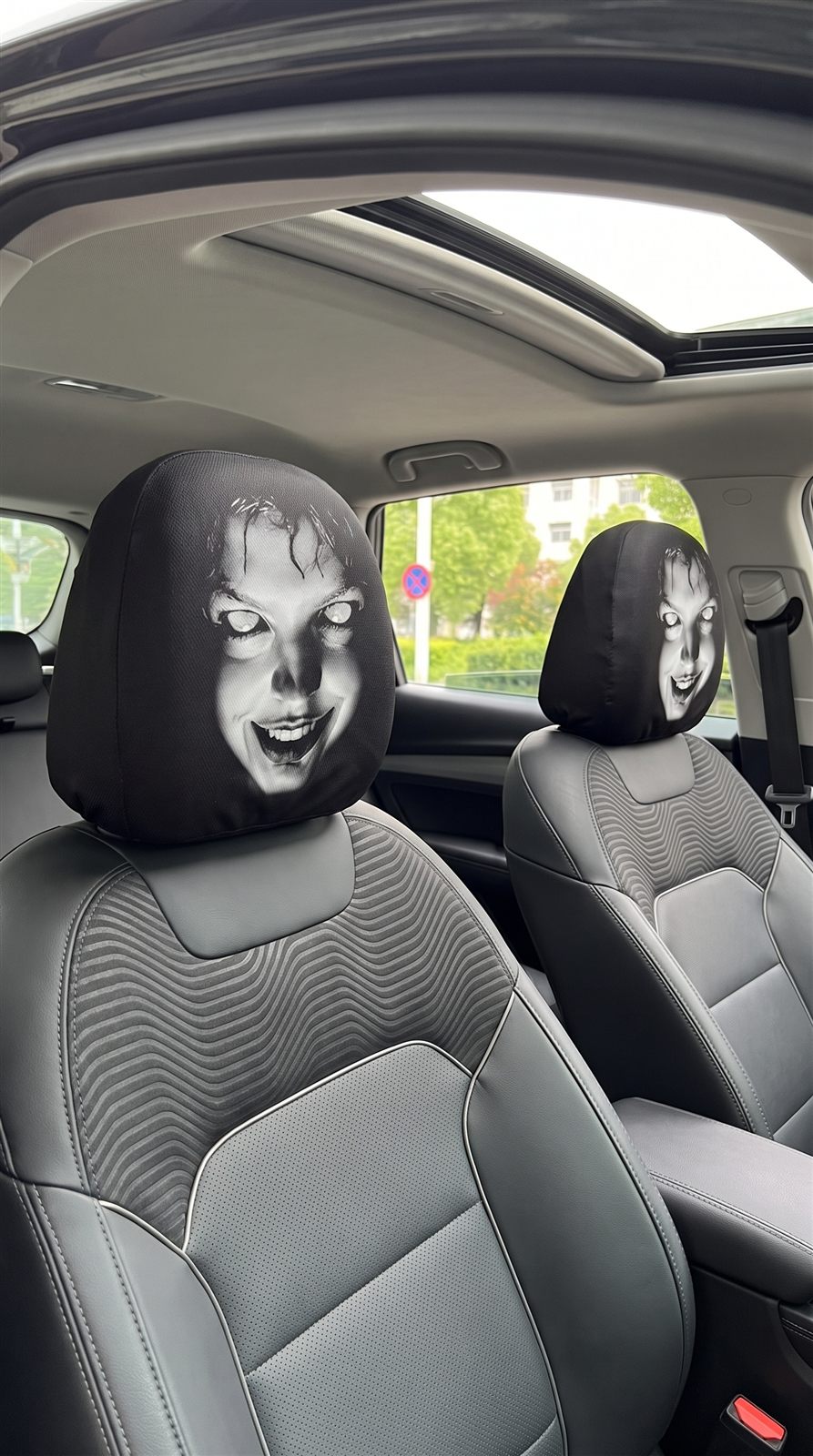 Halloween face covers fitted over car headrests