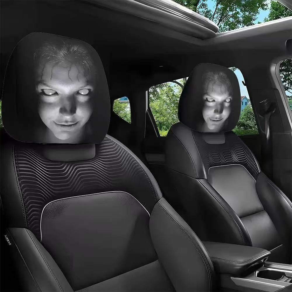 Set of two black car headrest covers with a cracked white-eyed horror face