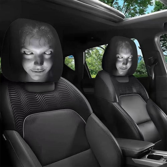 Set of two black car headrest covers with a cracked white-eyed horror face
