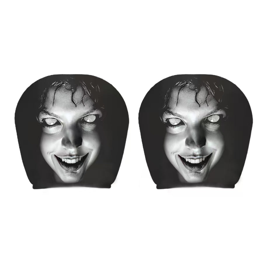 Pair of black car headrest covers with a wide-grin white-eyed horror face