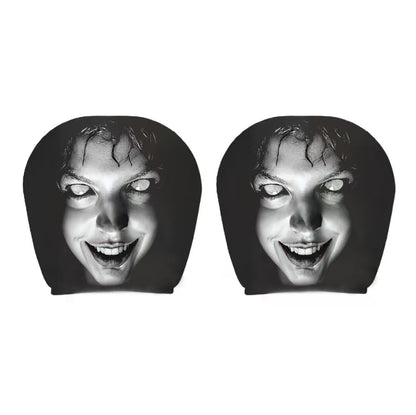 Pair of black car headrest covers with a wide-grin white-eyed horror face
