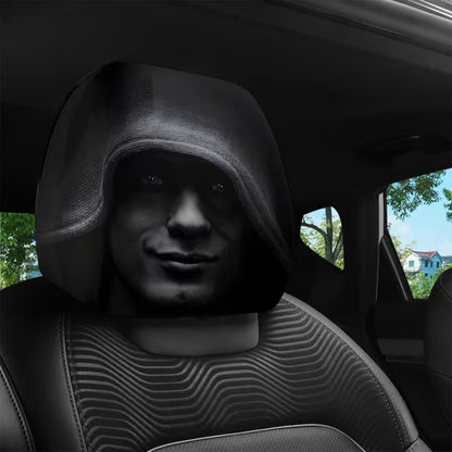 Black car headrest cover with a shadowed hooded face on the front seat